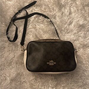 Brown and white Coach crossbody bag